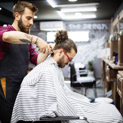 young-bearded-man-getting-haircut-by-hairdresser-w-2021-08-29-09-42-52-utc.jpg